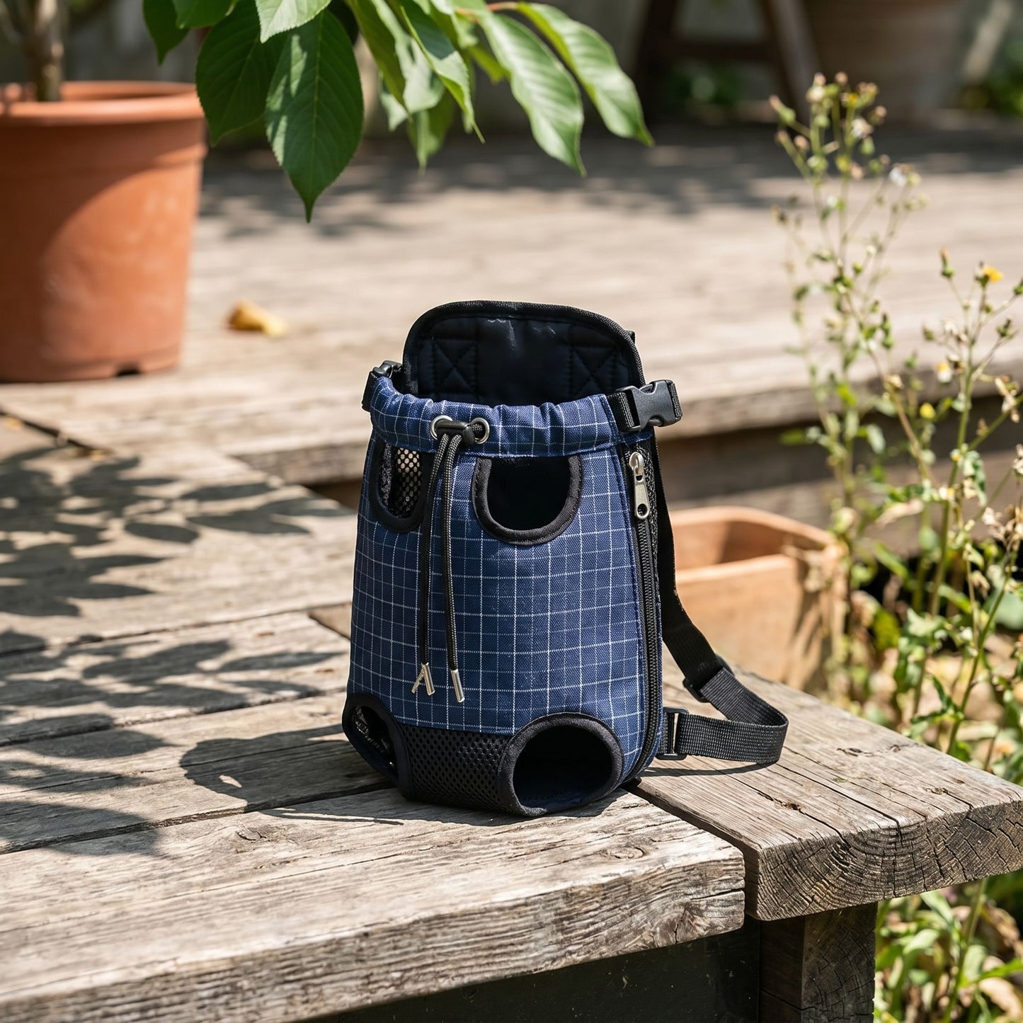 Full-body view of a compact pet carrier on a rustic wooden surface in outdoor daylight.