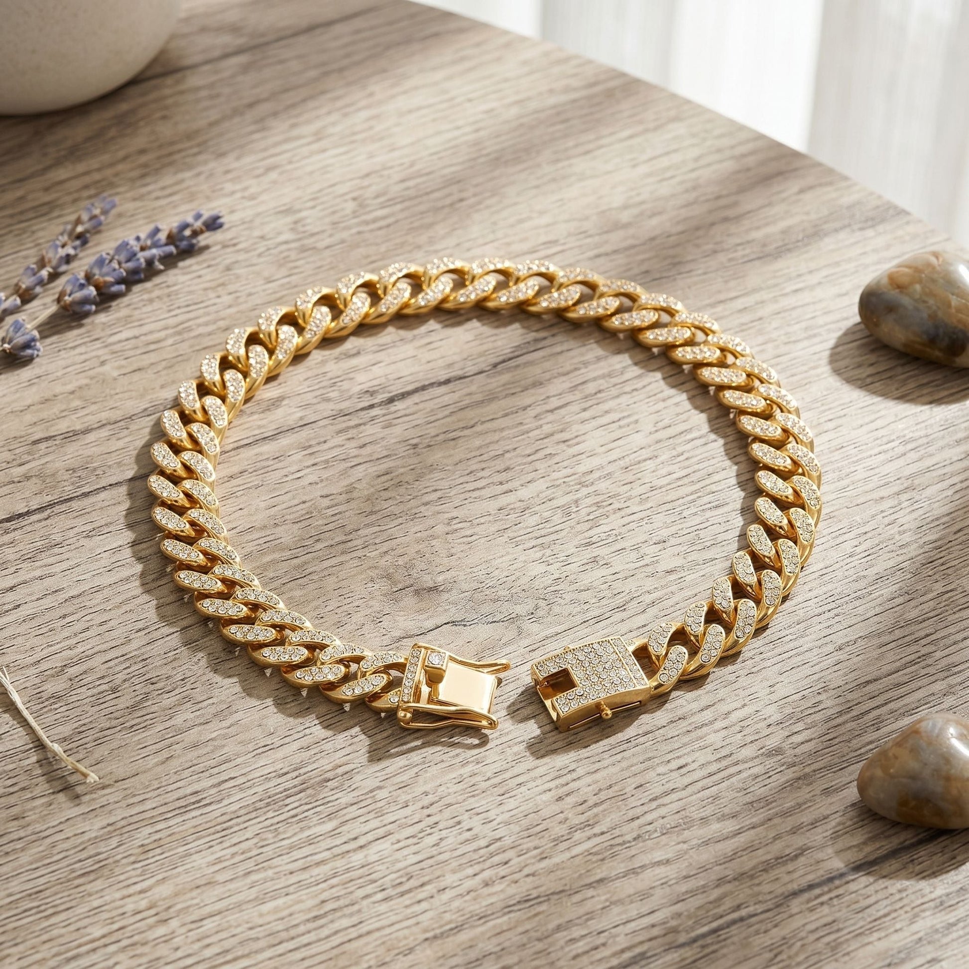 Overhead view of a crystal-embellished Cuban chain on a wooden surface, emphasizing detailed design and craftsmanship.