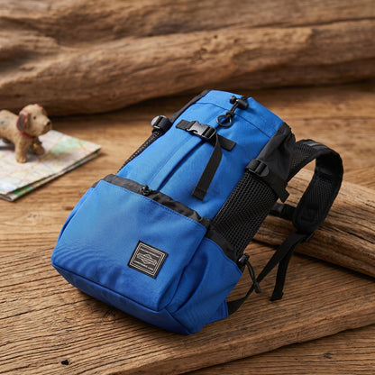Product shot of nylon dog backpack on wooden surface highlighting stitching, texture, and ventilation panels.