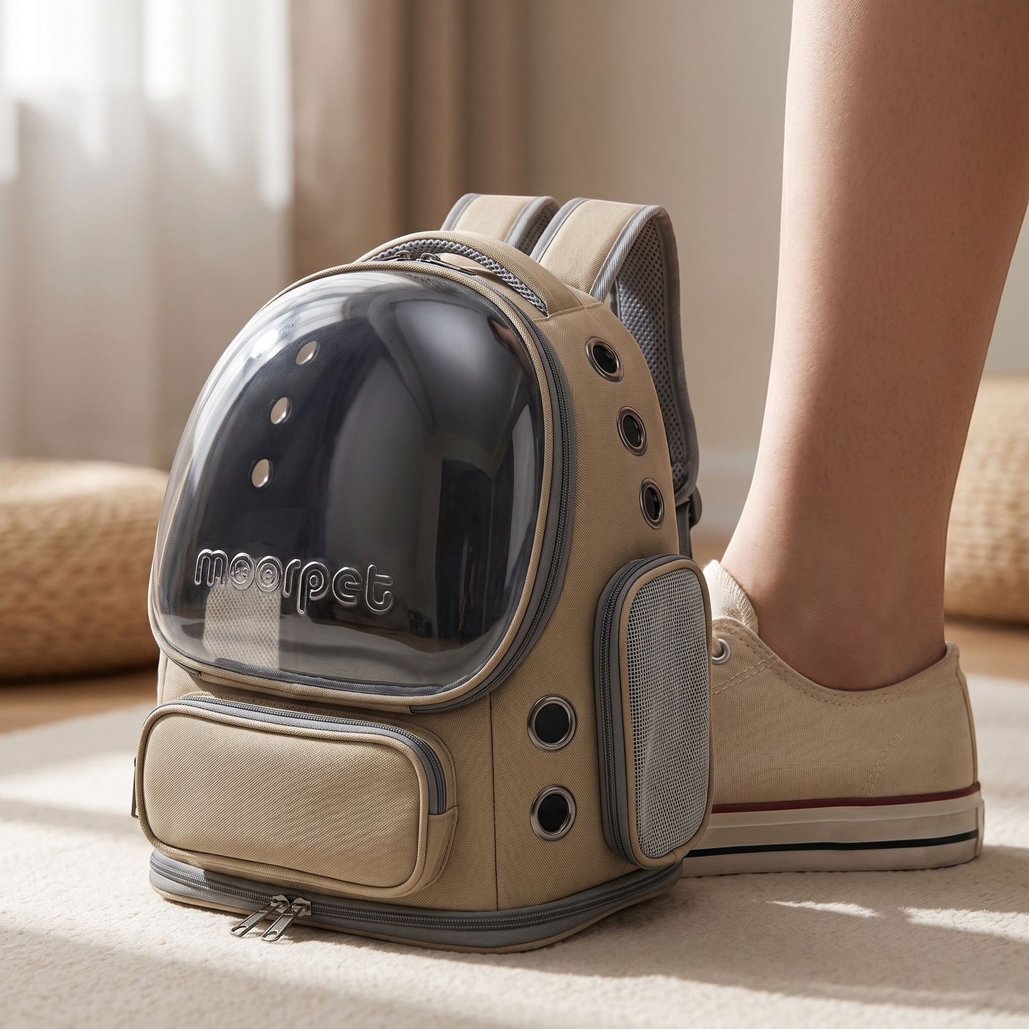 Close-up of a small khaki nylon cat carrier backpack highlighting its micro-texture, zipper, and ventilation mesh with a neutral studio background.